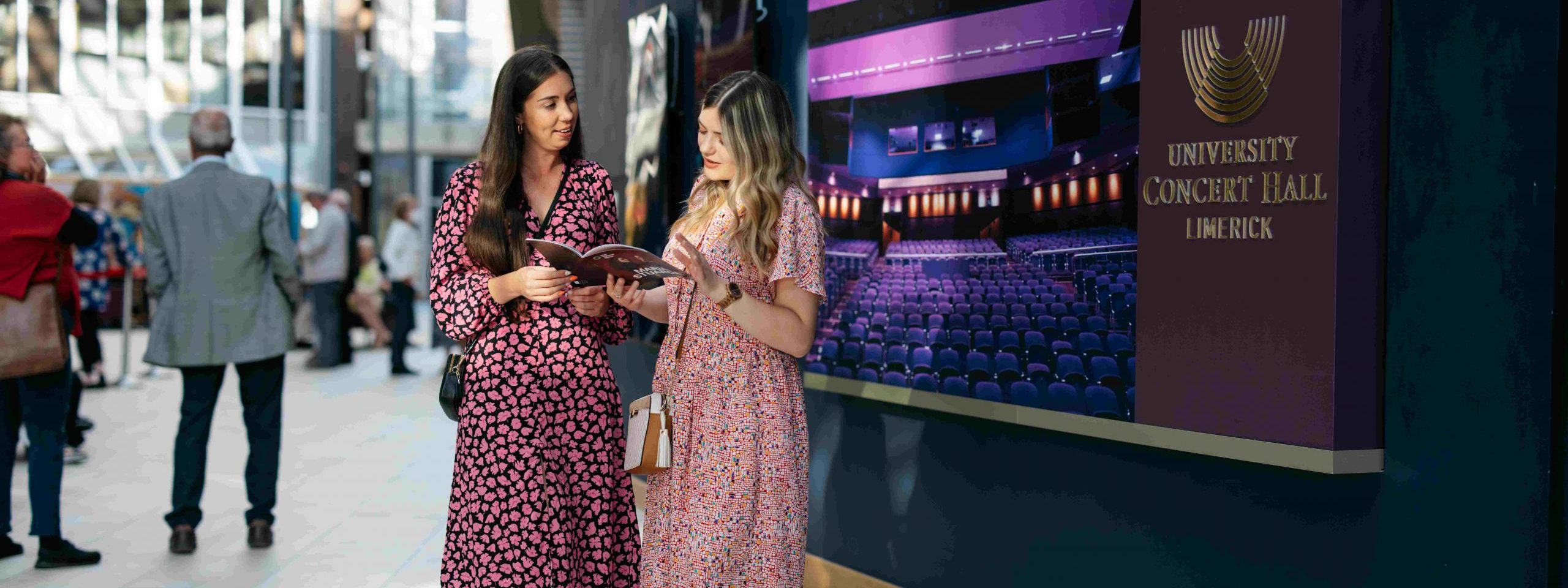 two women standing in front of UCH box office